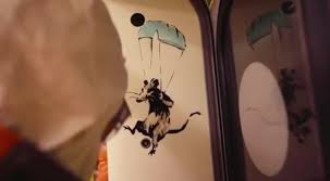 The nurse has her arm outstretched as she 'flies' through the sky. Banksy Covers London Tube With Images Of Rats And Face Masks