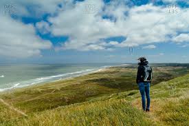 Find the perfect denmark landscape stock photo. Denmark Jutland Woman Standing In Dune Landscape Stock Photo Offset