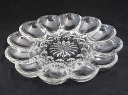 The plate is clear glass. Anchor Hocking Fairfield Egg Plate Clear Glass Deviled Egg Tray