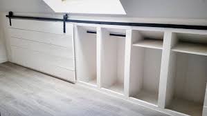 Attic Closet Ideas Walk In Attic Room Wardrobe Includes A Sloped Ceiling Lined With Rustic Wood Beam Attic Rooms Attic Bedroom Storage Attic Bedroom Closets