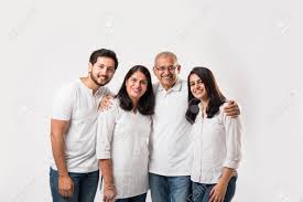 Happy Indian Family Standing Isolated Over White Background. Senior Parents  With Young Kids Wearing White Top And Blue Jeans. Selective Focus Stock  Photo, Picture and Royalty Free Image. Image 117728666.