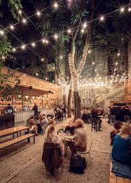 This Ruin Pub In Budapest Is A Chic Modern Take On The Traditional Romkocsma Outdoor Restaurant Patio Coffee Shop Interior Design Beer Garden Design