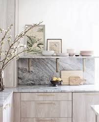 Beautiful Marble And Light Colored Wood Cabinets With Exposed Wood Grain A Long Built In Shelf Takes The Plac Home Decor Kitchen Kitchen Trends Kitchen Marble