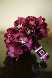 These gorgeous galaxy orchid and white rose bouquet are perfect for any bright color, fun loving bride and her bridesmaids. Sangria Colored Bouquet Of Stunning Cymbidium Orchids Summer Wedding Bouquets Orchid Bouquet Bridal Bouquet