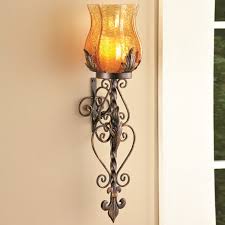 These sconces typically feature a glass container that houses a candle, with easy access to the candle for lighting, extinguishing and replacement. Glass Wall Sconce Candle Holder Collections Etc