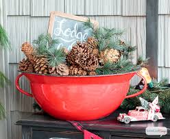 A pretty farmhouse christmas porch with snowy christmas trees in crates, an evergreen garland with lights over the door, candle lanterns. Front Porch Decorating Ideas You Ll Want To Copy For Christmas