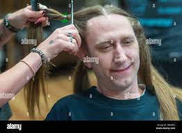 Aaron Deininger (C) of Reading, Pa. has his hair cut by Ella Curry of  Flourtown, Pa. during the 16th Annual Kathy's Cuts benefitting Wigs for  Kids charity Friday, May 02, 2025 at