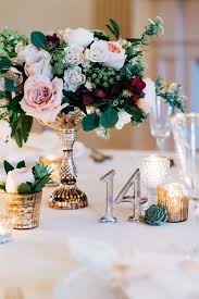 Beautiful smiling young florist leaning at table with open sign. 19 Best Burgundy Floral Centerpieces Ideas Floral Centerpieces Wedding Decorations Wedding Flowers