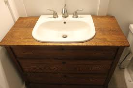 That dresser stashed in the garage can have a new life as a retrofitted bathroom vanity with the addition of a sink and a mirror. Turning A Dresser Into A Bathroom Vanity