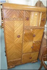 Typically the wardrobe section runs down one side of the piece, while the drawers occupy the other side. Art Deco Waterfall Bedroom Suite Including Mirrored Dresser Chiffarobe And Double Bed With Rails