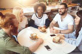 Togetherness And Community Startup Team Sitting At Round Table At Cafe Discussing Business Strategy And Plans Multiethnic Group Meeting At Coworking Space T Togetherness Business Strategy Coworking