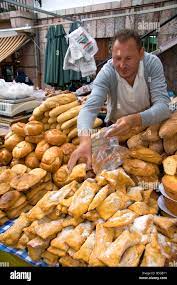 Vendor Selling Bread And Baked Goods At An Outdoor Market In The Town Of  Cangas De Onis Asturias Northern Spain Stock Photo - Alamy