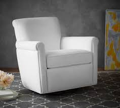 Piping along the seams of the supple leather adds a subtly tailored look and plush cushions and roll arms provide superb comfort. Irving Upholstered Swivel Rocker Pottery Barn
