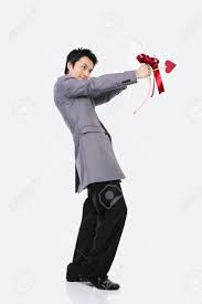 Male Asian In Suit Posing In A Studio With Cupid Arrows Stock Photo,  Picture And Royalty Free Image. Image 85328486.