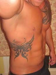 A violet butterfly tattoo wrapped around his right rib cage and dipped into the waist of his pants. 8 Lords Of The Underworld Tattoos Ideas Underworld Tattoos Lord