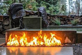 Linear In Ground Gas Fire Pit In Front Of Stone And Concrete Water Feature Modern Fire Pit Fire Pit Wall Fire Pit Decor