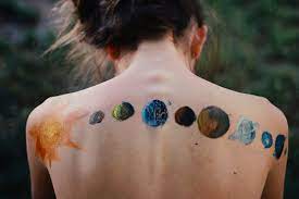Colored universe tattoo on man left sleeve. 9 Upper Back Universe Tattoos