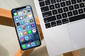 Iphone X Lying On Glass Table Next To Macbook Laptop Iphone Macbook Laptop Macbook
