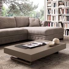 A rectangular white foldout top of wood rotates 90 degrees. Extendable Table From Coffee Table To Dining Table Gilmore