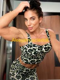 Strong brunette babe Alesya showing off her big muscles photos