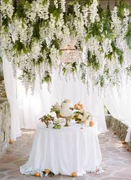 Groupings of these flower vases look lovely hanging from tree branches. Hanging Wedding Flowers The Biggest Boldest Floral Trend For Wedding Decor
