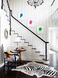 The handrails are stained to match the carpet and a luxe, charcoal velvet settee provides a plush spot to sit at the base of the stairs. How To Decorate A Staircase Wall The Zhush Blog