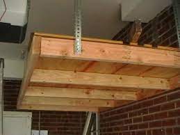 How To Install A Hanging Shelf In Garage Or Workshop Ehow Hanging Garage Shelves Garage Organization Shelves Hanging Shelves