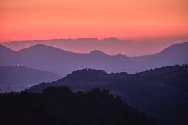 Aerial view of city buildings during sunset. Purple Sunset At The Mountains Last Night Photograph By Guido Montanes Castillo