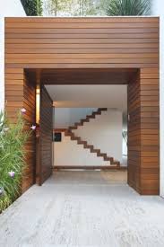 The Lines Created By The Cladding The Door And The Steps Behind Make A Dramatic Statement With No Need For Further E Door Design Architecture Entrance Design