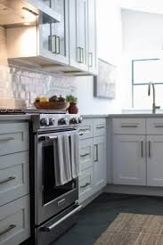 Coastal Modern Kitchen With Light Gray Cabinets And White Backsplash In 2020 Transitional Kitchen Design Modern Kitchen Light Gray Cabinets