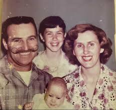 picture is not in to good of shape but this is me and my sister and mom and  dad, i'm the little blonde one