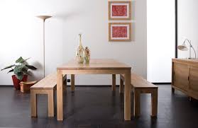 It is mounted on wooden legs and upholstered with faux leather. Ethnicraft Oak Straight Dining Table