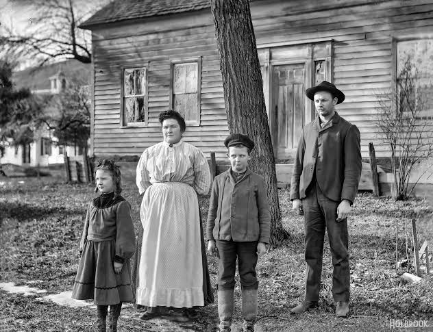 Early 20th century family photo outside their home
