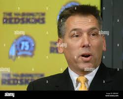 New Virginia head football coach and longtime Clemson assistant coach Tony  Elliott, right, his wife Tamika Elliott, left, and sons, A.J., front left,  and Ace, front right, pose for pictures prior to