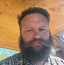 Rocky truck pulling a tiny home through a driveway