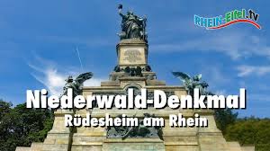Eine landstraße führt von rüdesheim durch die weinberge steil hinauf zum niederwalddenkmal, zum jagdschloss niederwald, nach aulhausen und an aulhausen vorbei nach presberg. Niederwald Denkmal Rudesheim Rhein Eifel Tv Youtube