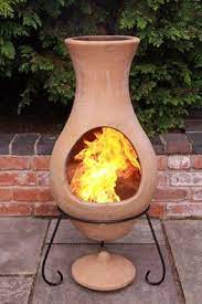 This wood burning fire pit conveniently features an opening that provides easy access to the fire to keep it going during outdoor gatherings. Four Elements Clay Chiminea Air Medium Chimineashop Co Uk Clay Chiminea Outdoor Fire Pit Chiminea