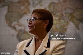 Jean Kabre, R, talks with co-workers Justine Osborne, L, and Daniel... News  Photo