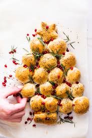 Take a ball of dough, roll or press into a circle, place a spoonful of cheese filling in the middle and gather up the edges of the dough, pressing well to seal. Cheesy Christmas Tree Pull Apart Bread Simply Delicious