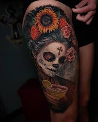 The basic traditional meaning of the sugar skull is that it celebrates life. Day Of The Dead Thigh Tattoo