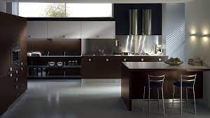 The dark wood island contrasts with the sleek smooth granite countertop, providing both visual and textural intrigue. Sleek Modern Kitchen Looks Like A Posh Contemporary Office Modern Kitchen Colours Kitchen Design Color Modern Kitchen Design