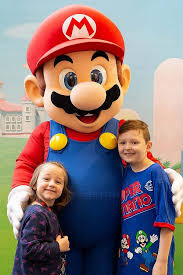 Kids Pose With Nintendo Star Mario Gaming Station Kids Entertainment Kids