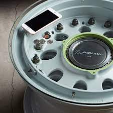 Thick black metal wraps the edges for a bold and functional look. These Coffee Tables Are Made From The Wheel Of Boeing Airliners