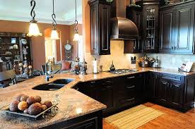 This dreamy mountain kitchen features sleek black shaker cabinets with large wood beams, a natural stone accent wall, and plenty of overhead lighting to keep the space bright. Harry Potter Close Up Hermione Hoodie Dark Brown Kitchen Cabinets Home Kitchens Kitchen Design