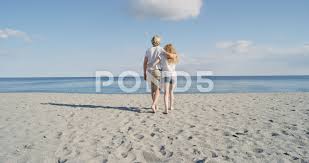 Young Couple Walking Towards Ocean Enjoying Summer Fun Vacation Travel Concept Stock Footage Ocean Enjoying Summ Vacation Trips Best Vacations Couples Walking