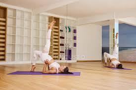 Whole body bridge formation pose. Side View Of Flexible Female With Eyes Closed Performing Eka Pada Setu Bandha Sarvangasana Pose While Practicing Yoga In Studio Leggings Happy Stock Photo 461554886