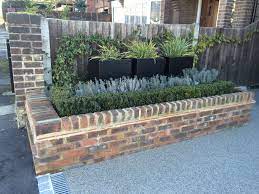 Raised Brick Bed With Buxus Hedge And Lavender Planters With Molinia And Trachelospermum Jasminoides To Fe Brick Planter Building A Raised Garden Brick Garden