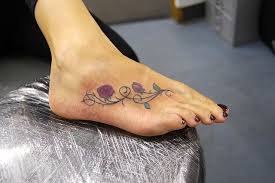 Burnished stars, decorating curvilinear lines, text, nautical stars, small burnished stars and floral vines are some of the most popular images those can be featured with these kinds of designs. Rose And Vines Foot Tattoo Vine Foot Tattoos Rose Vine Tattoos Tattoos For Women Flowers