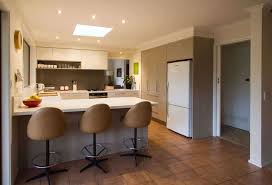 The dark, moody tile walls, sleek backsplash, and stainless steel appliances assert an undeniably glam aesthetic while the wood and brass tones ground the space and give it that classic classic califorina warmth. G Shape Kitchen Designs G Shape Kitchen In Delhi Noida Ghaziabad Gurgaon Faridabad