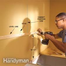 How to install wall cabinets. How To Install Kitchen Cabinets Diy Family Handyman